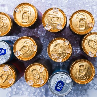 Group of aluminium cans in ice, cold drink. Top view.